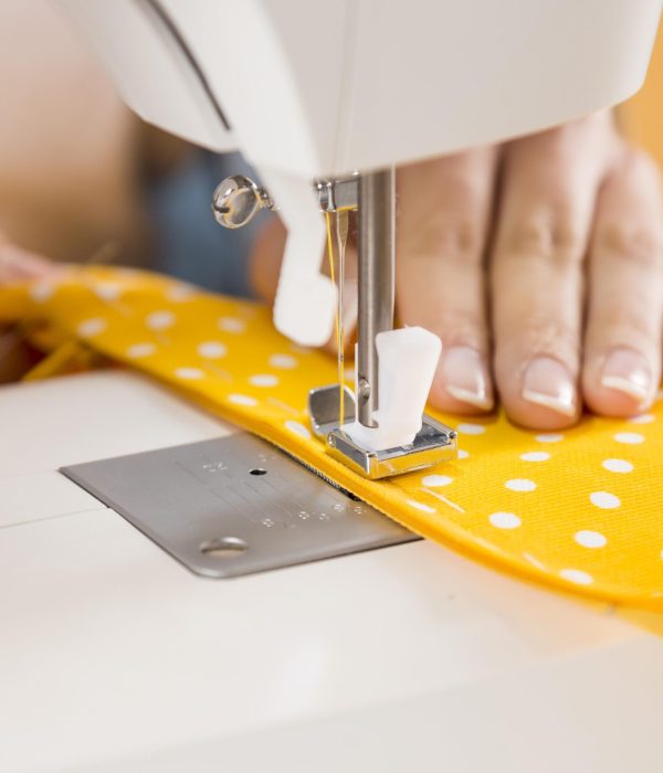close-up-hands-sewing-with-machine